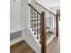 Wooden staircase with dark metal railing and hall tree provides great functionality at 557 Red Clay Farm Ln, Suwanee, GA 30024