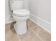White toilet in modern bathroom with neutral-toned flooring at 557 Red Clay Farm Ln, Suwanee, GA 30024