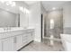 Bathroom with double vanity, and a glass-enclosed shower at 577 Red Clay Farm Ln, Suwanee, GA 30024