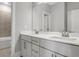Modern bathroom featuring double sink vanity, quartz countertop and view of walk-in tiled shower at 577 Red Clay Farm Ln, Suwanee, GA 30024
