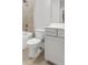 Modern bathroom featuring tiled walk-in shower, white toilet, and vanity with a quartz countertop at 577 Red Clay Farm Ln, Suwanee, GA 30024