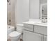 Modern bathroom featuring tiled walk-in shower, white toilet, and vanity with a quartz countertop at 577 Red Clay Farm Ln, Suwanee, GA 30024