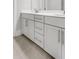 Bathroom vanity with white cabinets, quartz countertop, silver hardware and tile floors at 577 Red Clay Farm Ln, Suwanee, GA 30024
