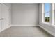 A bright bedroom offers new carpet, base trim, light gray paint, and a double door closet at 577 Red Clay Farm Ln, Suwanee, GA 30024