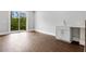 Bonus Room featuring hardwood floors, wet bar area with sink and sliding glass doors to outdoor porch at 577 Red Clay Farm Ln, Suwanee, GA 30024
