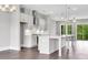 Modern kitchen with gray cabinets, pendant lighting, stainless appliances, and hardwood floors at 577 Red Clay Farm Ln, Suwanee, GA 30024