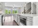 Modern kitchen with stainless steel appliances, center island, and lots of natural light at 577 Red Clay Farm Ln, Suwanee, GA 30024