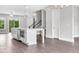Open kitchen featuring a large island, stainless steel appliances, and luxury vinyl plank flooring at 577 Red Clay Farm Ln, Suwanee, GA 30024
