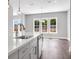 Kitchen featuring white cabinets, a large island, stainless steel appliances, and hardwood floors at 577 Red Clay Farm Ln, Suwanee, GA 30024