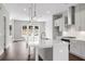 Bright modern kitchen with white cabinets, stainless steel appliances, hardwood floors, and an island at 577 Red Clay Farm Ln, Suwanee, GA 30024