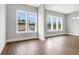 Spacious living room with hardwood floors, recessed lighting, and large windows for plenty of natural light at 577 Red Clay Farm Ln, Suwanee, GA 30024