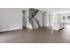 Open-concept living room features hardwood floors, gray walls, and staircase at 577 Red Clay Farm Ln, Suwanee, GA 30024