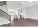 Bright open-concept living space with wood floors flowing into the modern kitchen area at 577 Red Clay Farm Ln, Suwanee, GA 30024