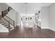 A large living room features hardwood floors and an open staircase at 577 Red Clay Farm Ln, Suwanee, GA 30024