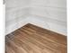 Walk-in pantry with white wire shelving and wood-look floors at 577 Red Clay Farm Ln, Suwanee, GA 30024