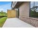 Private brick patio with view of manicured lawn, privacy fence, and landscaped backyard at 577 Red Clay Farm Ln, Suwanee, GA 30024