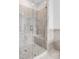 The glass shower features marble-style tile, a bench, and updated hardware at 577 Red Clay Farm Ln, Suwanee, GA 30024