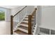 Beautiful staircase with stained wood steps, white risers, and an elegant dark metal railing at 577 Red Clay Farm Ln, Suwanee, GA 30024