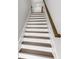 Staircase view highlighting wood treads and white risers at 577 Red Clay Farm Ln, Suwanee, GA 30024