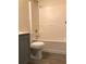 Bathroom featuring a white shower and tub combination, and a toilet with modern gray cabinetry at 2143 Gwinn Dr, Norcross, GA 30071