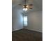 Neutral bedroom with carpet flooring, ceiling fan, and window providing natural light at 2143 Gwinn Dr, Norcross, GA 30071