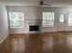 Bright living room featuring fireplace, multiple windows and hardwood floors at 2143 Gwinn Dr, Norcross, GA 30071