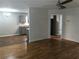 Open-concept living room and kitchen area with hardwood floors and ceiling fan at 2143 Gwinn Dr, Norcross, GA 30071