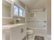 Bright bathroom featuring a soaking tub with tile surround, marble floors, and modern vanity with white cabinets at 385 Arthur Sw St, Atlanta, GA 30310