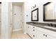 A well-lit bathroom featuring a double sink vanity, walk-in shower and tile flooring at 475 Letchas Ln, Alpharetta, GA 30009