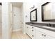 A well-lit bathroom featuring a double sink vanity, walk-in shower and tile flooring at 475 Letchas Ln, Alpharetta, GA 30009