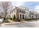 Attractive brick townhouse with well-maintained landscaping, a covered porch, and classic architectural details at 475 Letchas Ln, Alpharetta, GA 30009