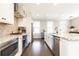 Modern white kitchen with stainless steel appliances, granite counters and a large island with bar seating at 475 Letchas Ln, Alpharetta, GA 30009