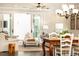 Bright living room flows into dining area with dark hardwood floors, fireplace, and sliding doors to screened porch at 475 Letchas Ln, Alpharetta, GA 30009