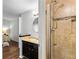 Ensuite bathroom with shower featuring tile surround, vanity, and ample lighting at 8834 Applegate Ln, Atlanta, GA 30350