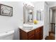 Well-lit bathroom with a vanity, modern lighting, and essential toiletry items at 8834 Applegate Ln, Atlanta, GA 30350