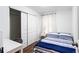 Cozy bedroom featuring wood floors, a closet with sliding doors, and a bright white and blue striped bed at 8834 Applegate Ln, Atlanta, GA 30350