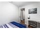 Minimalist bedroom with wood-look floors and an open doorway leading to a bathroom or hallway at 8834 Applegate Ln, Atlanta, GA 30350