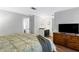 Cozy bedroom with a view of the ensuite bathroom, a dresser, and a TV at 8834 Applegate Ln, Atlanta, GA 30350