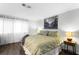 Bright bedroom with large bed, wood floors, and ample natural light from large window at 8834 Applegate Ln, Atlanta, GA 30350