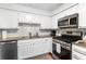 Updated kitchen featuring granite countertops, stainless steel appliances, and white cabinets at 8834 Applegate Ln, Atlanta, GA 30350