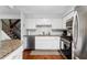 Bright kitchen with stainless steel appliances, white cabinetry, and hardwood floors at 8834 Applegate Ln, Atlanta, GA 30350