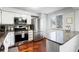 Modern kitchen featuring stainless steel appliances, granite countertops, and hardwood floors at 8834 Applegate Ln, Atlanta, GA 30350