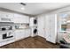 Charming kitchenette featuring white appliances, with a stackable washer/dryer, and vinyl flooring at 8834 Applegate Ln, Atlanta, GA 30350