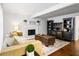 Bright living room featuring hardwood floors, fireplace, and dark entertainment center at 8834 Applegate Ln, Atlanta, GA 30350