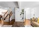 Living room featuring wood floors, staircase, and decorative shelving at 8834 Applegate Ln, Atlanta, GA 30350