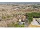 Aerial view of the property showcasing its wooded surroundings, neighborhood, and detached garage at 11637 Brown Bridge Rd, Covington, GA 30016