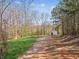 Expansive yard with a white outbuilding nestled among mature trees, creating a serene outdoor space at 11637 Brown Bridge Rd, Covington, GA 30016