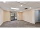 Bright finished basement with neutral walls, carpet, and french doors leading to the outside at 11637 Brown Bridge Rd, Covington, GA 30016