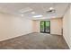 Spacious basement with plush carpet and French doors to the outside at 11637 Brown Bridge Rd, Covington, GA 30016