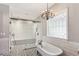 This bright bathroom features a soaking tub, walk-in shower, and stylish patterned tile flooring at 11637 Brown Bridge Rd, Covington, GA 30016